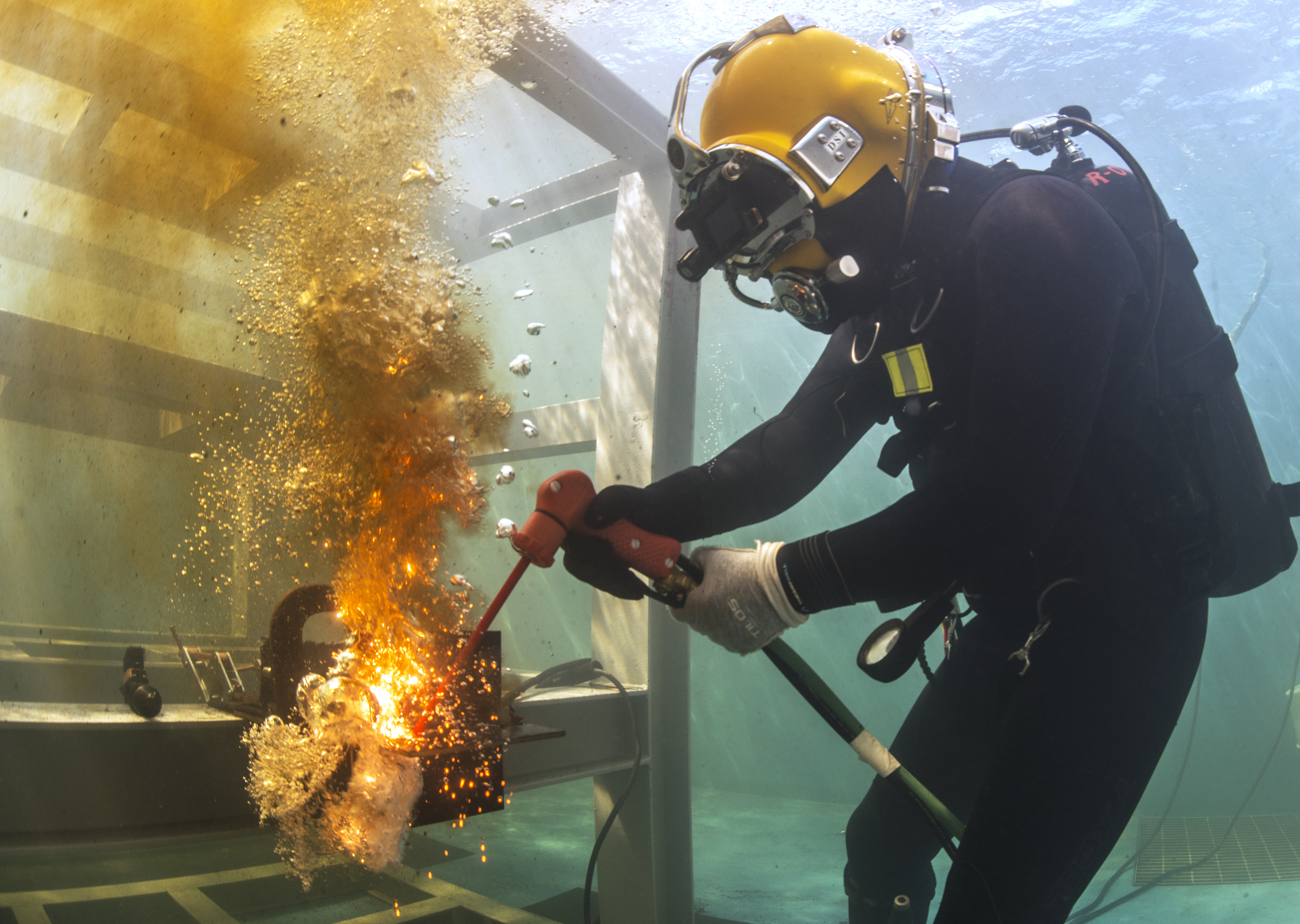 U.S. Navy Lt. Christopher Ferguson, NECC dive medical officer for the Underwater Construction Teams, cuts a steel plate with an exothermic cutting torch in a training pool at the Republic of Korea (ROK) engineering school at Jinhae, ROK, March 17, 2016 during exercise Foal Eagle 2016. Foal Eagle is an annual, bilateral training exercise designed to enhance the readiness of U.S. and ROK forces, and their ability to work together during a crisis. (U.S. Navy combat camera photo by Mass Communication Specialist 1st Class Charles E. White/Released)